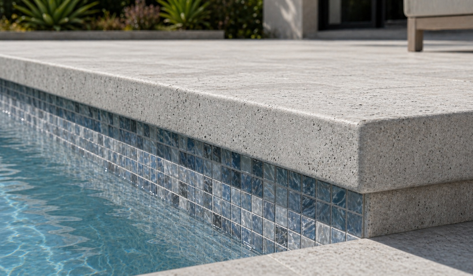 Detail view of thicker silver travertine coping on a crisp modern pool edge